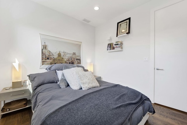 bedroom with wood finished floors, visible vents, and recessed lighting