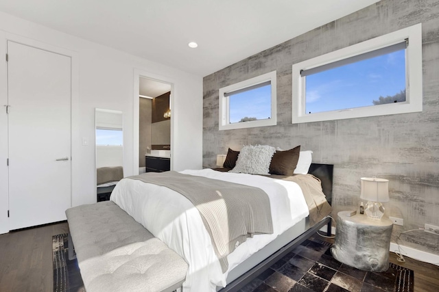 bedroom featuring recessed lighting, wood finished floors, and ensuite bathroom