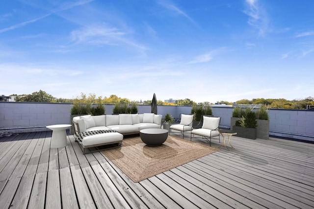 wooden terrace featuring a water view and an outdoor living space