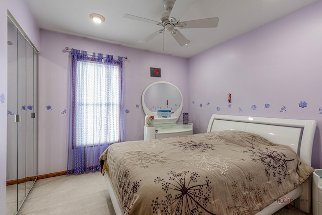 bedroom featuring light carpet, a closet, a ceiling fan, and baseboards