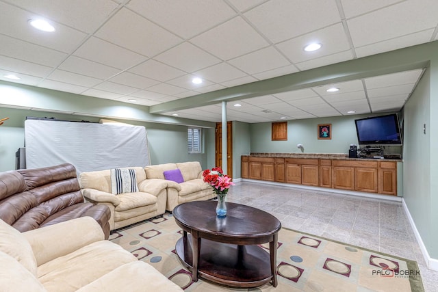 living area featuring recessed lighting, a paneled ceiling, and baseboards