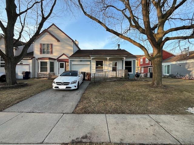 traditional-style house featuring a garage, covered porch, a chimney, and aphalt driveway