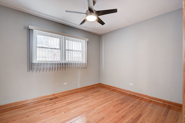 unfurnished room with baseboards, visible vents, ceiling fan, and light wood finished floors