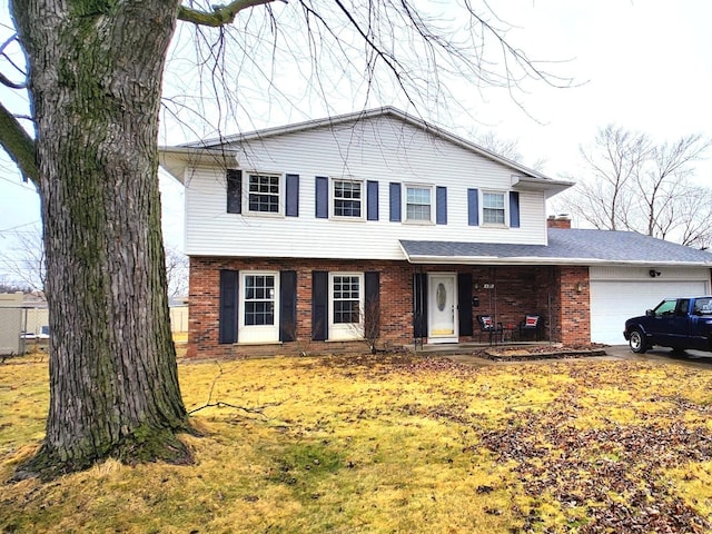 view of front of home featuring a garage and brick siding