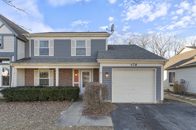 view of front facade with a garage, driveway, brick siding, and a shingled roof