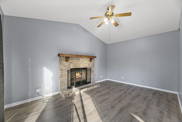 unfurnished living room featuring baseboards, a ceiling fan, lofted ceiling, wood finished floors, and a brick fireplace