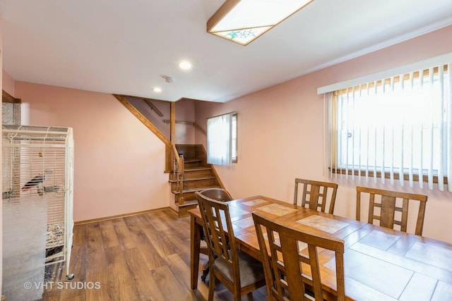 dining room with recessed lighting, stairway, baseboards, and wood finished floors