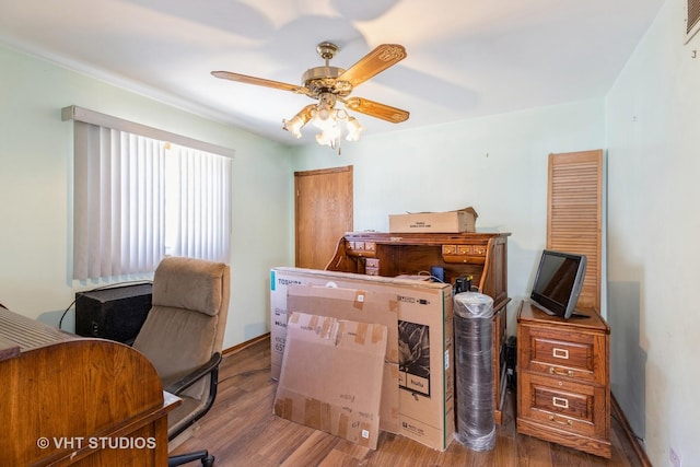 office space with a ceiling fan and wood finished floors