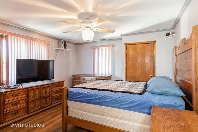 bedroom featuring ceiling fan, multiple windows, crown molding, and wood finished floors