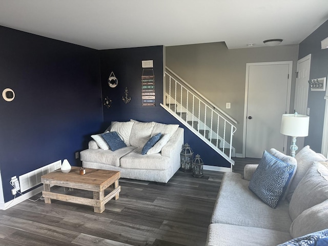 living room with stairway, baseboards, visible vents, and wood finished floors