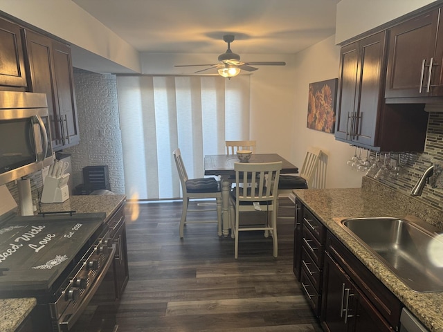 1057 Southgate Rd, New Lenox, IL 60451 - kitchen with stainless steel microwave, backsplash, a sink, dark brown cabinetry, and dark wood-style flooring