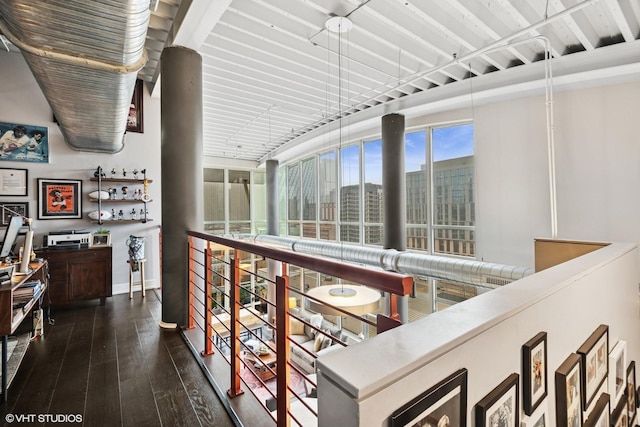 hallway featuring dark wood finished floors and a city view