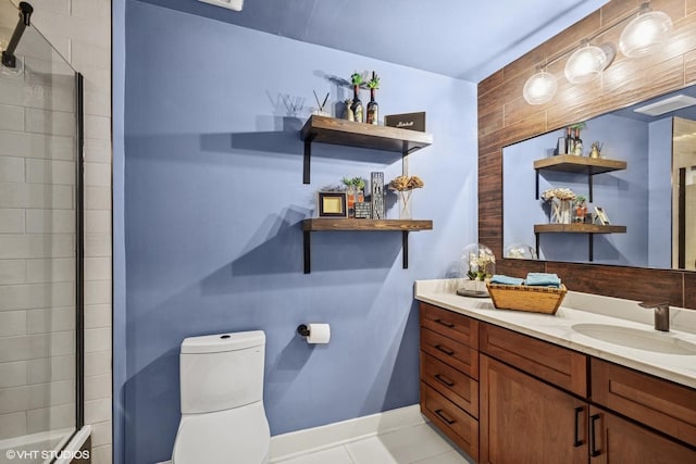 full bath featuring toilet, a shower with shower door, vanity, tile patterned flooring, and baseboards