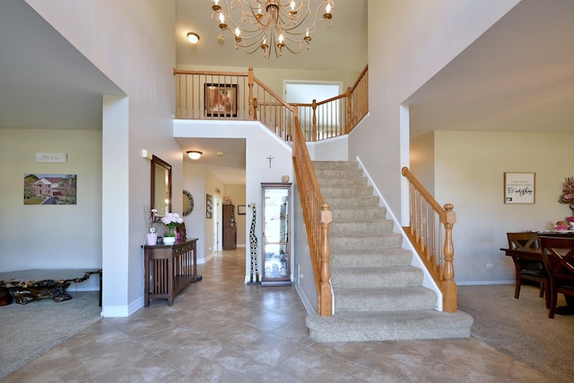 stairway featuring carpet floors, an inviting chandelier, and a towering ceiling