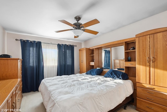 bedroom with light carpet and ceiling fan