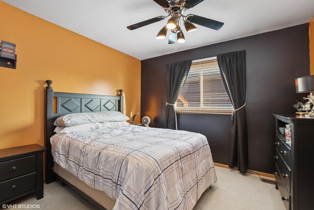 bedroom featuring light carpet, ceiling fan, and baseboards