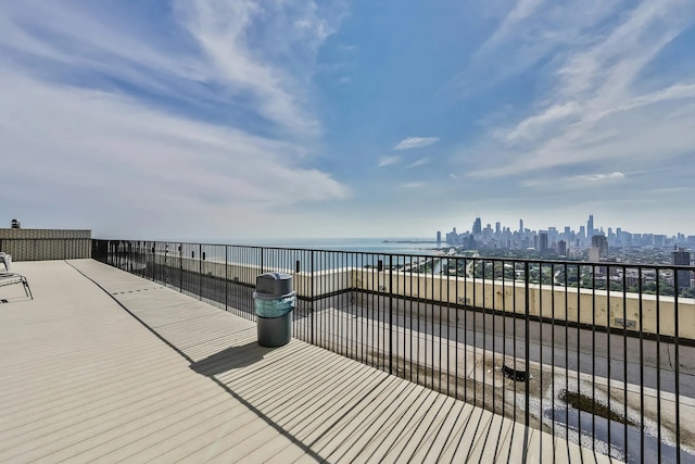 wooden deck featuring a view of city and a water view