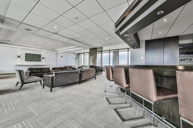 interior space with a dry bar, recessed lighting, a paneled ceiling, and light carpet