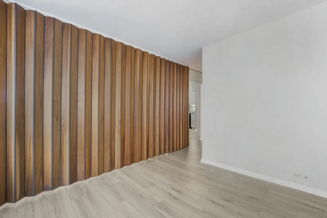 unfurnished room featuring wood finished floors and baseboards