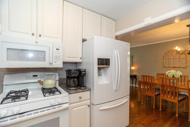 4128 N Plainfield Ave, Chicago, IL 60634 - kitchen featuring white appliances, wood finished floors, a chandelier, white cabinets, and tasteful backsplash