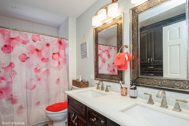 full bath with tasteful backsplash, a sink, toilet, and double vanity