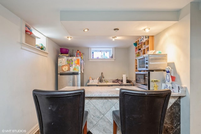 kitchen featuring freestanding refrigerator