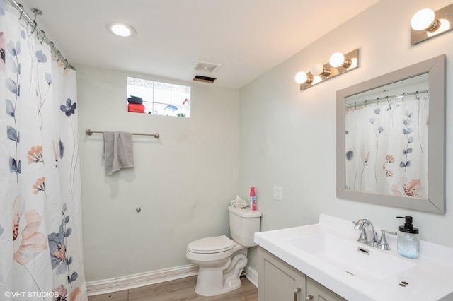 full bath featuring visible vents, toilet, vanity, wood finished floors, and baseboards