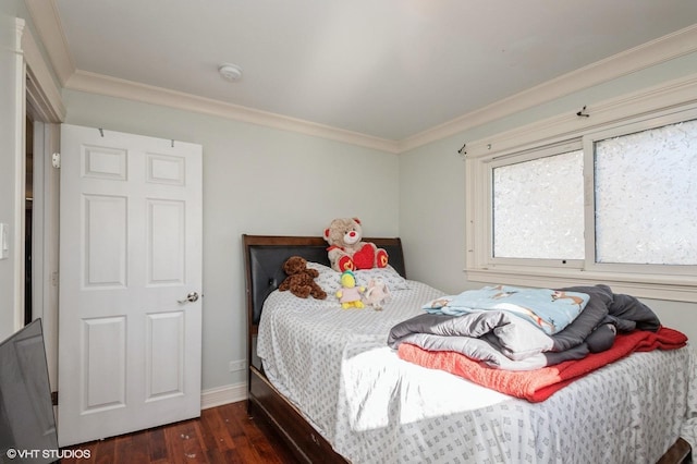 bedroom featuring ornamental molding, dark wood-type flooring, and baseboards