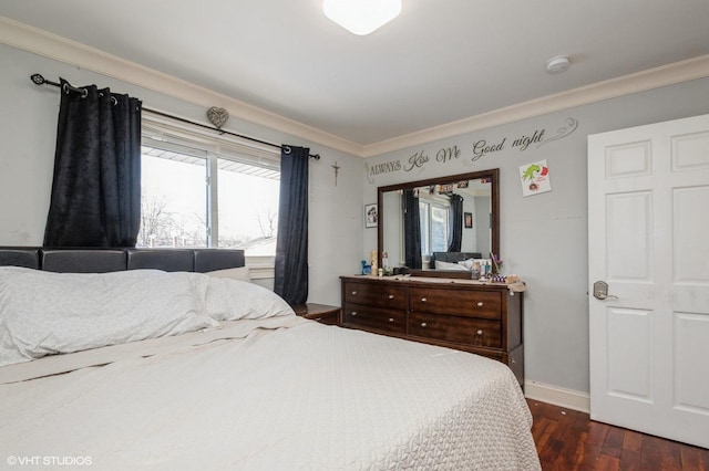 bedroom with baseboards, dark wood finished floors, and crown molding