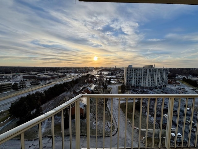 balcony at dusk with a view of city