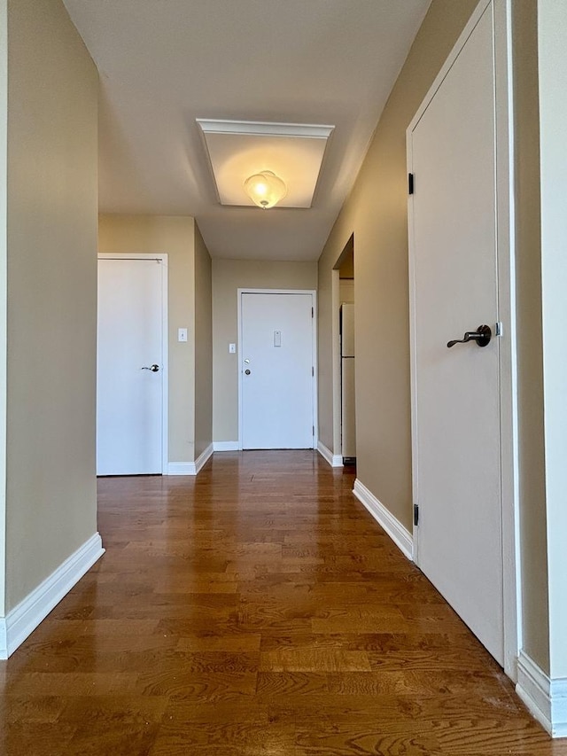 interior space with baseboards and wood finished floors