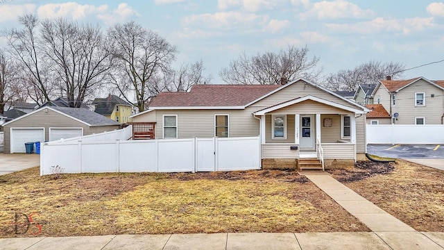 bungalow-style home featuring a garage, a porch, and fence