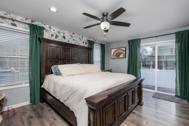 bedroom featuring ceiling fan, wood finished floors, baseboards, access to outside, and wallpapered walls