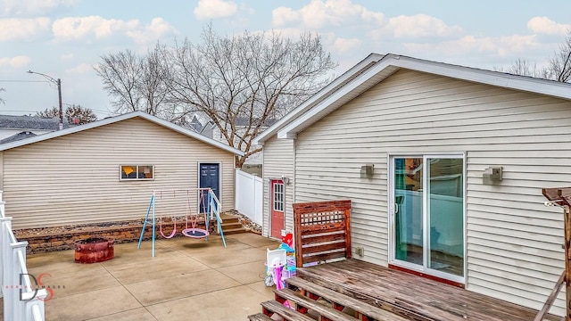 view of property exterior with a deck and a patio