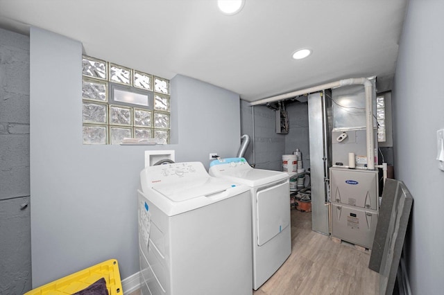 laundry area featuring washer and dryer, laundry area, light wood-style flooring, and recessed lighting