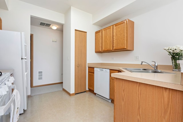 kitchen featuring a sink, visible vents, baseboards, and white dishwasher