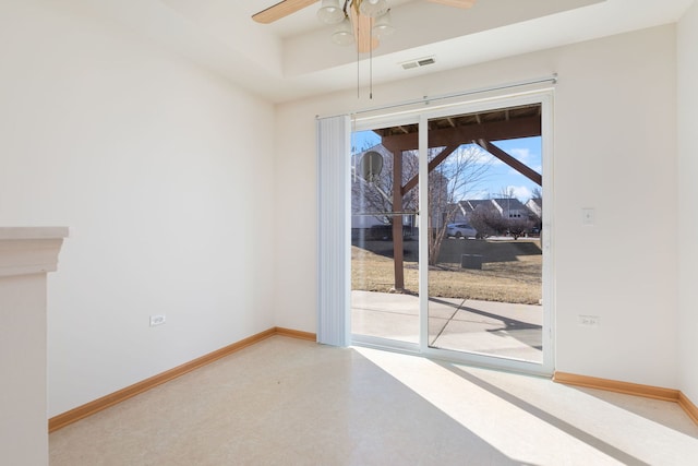 spare room featuring baseboards, visible vents, light floors, and ceiling fan