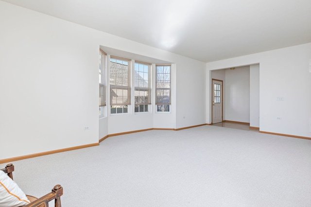 interior space with light colored carpet and baseboards