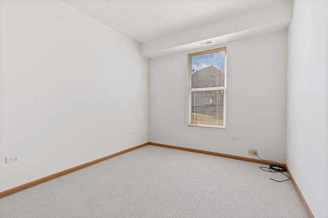 unfurnished room with baseboards, visible vents, and light carpet