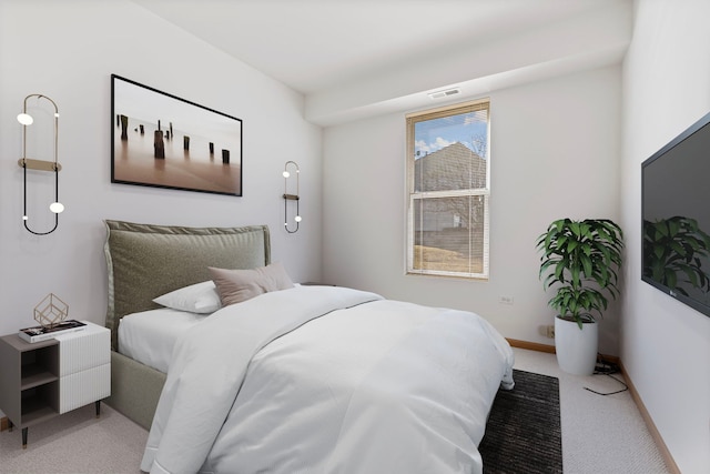 bedroom with baseboards, visible vents, and light carpet