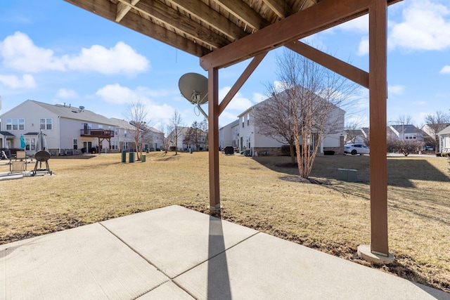 view of yard with a residential view and a patio area