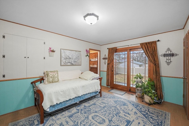 bedroom with access to exterior, visible vents, and ornamental molding