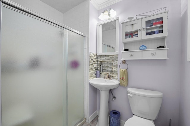 full bathroom featuring tasteful backsplash, baseboards, toilet, crown molding, and a shower stall