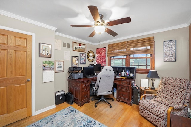 home office featuring light wood-type flooring, ceiling fan, visible vents, and ornamental molding