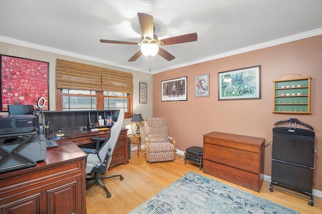 home office featuring baseboards, light wood-style flooring, ornamental molding, and a ceiling fan