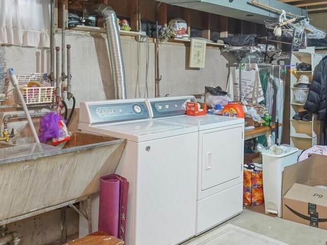 laundry room featuring laundry area, a sink, and independent washer and dryer