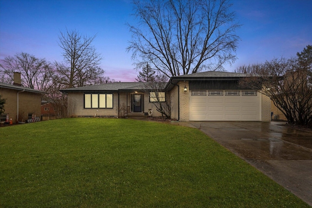 mid-century home with driveway, brick siding, an attached garage, and a front yard