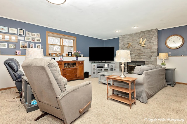 carpeted living room featuring baseboards, a stone fireplace, and crown molding