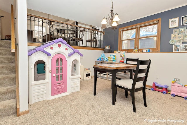 rec room with baseboards, a chandelier, and carpet flooring