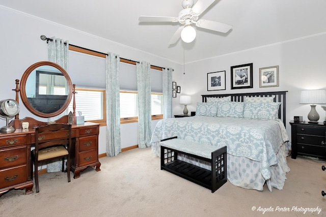 carpeted bedroom featuring a ceiling fan, crown molding, and baseboards